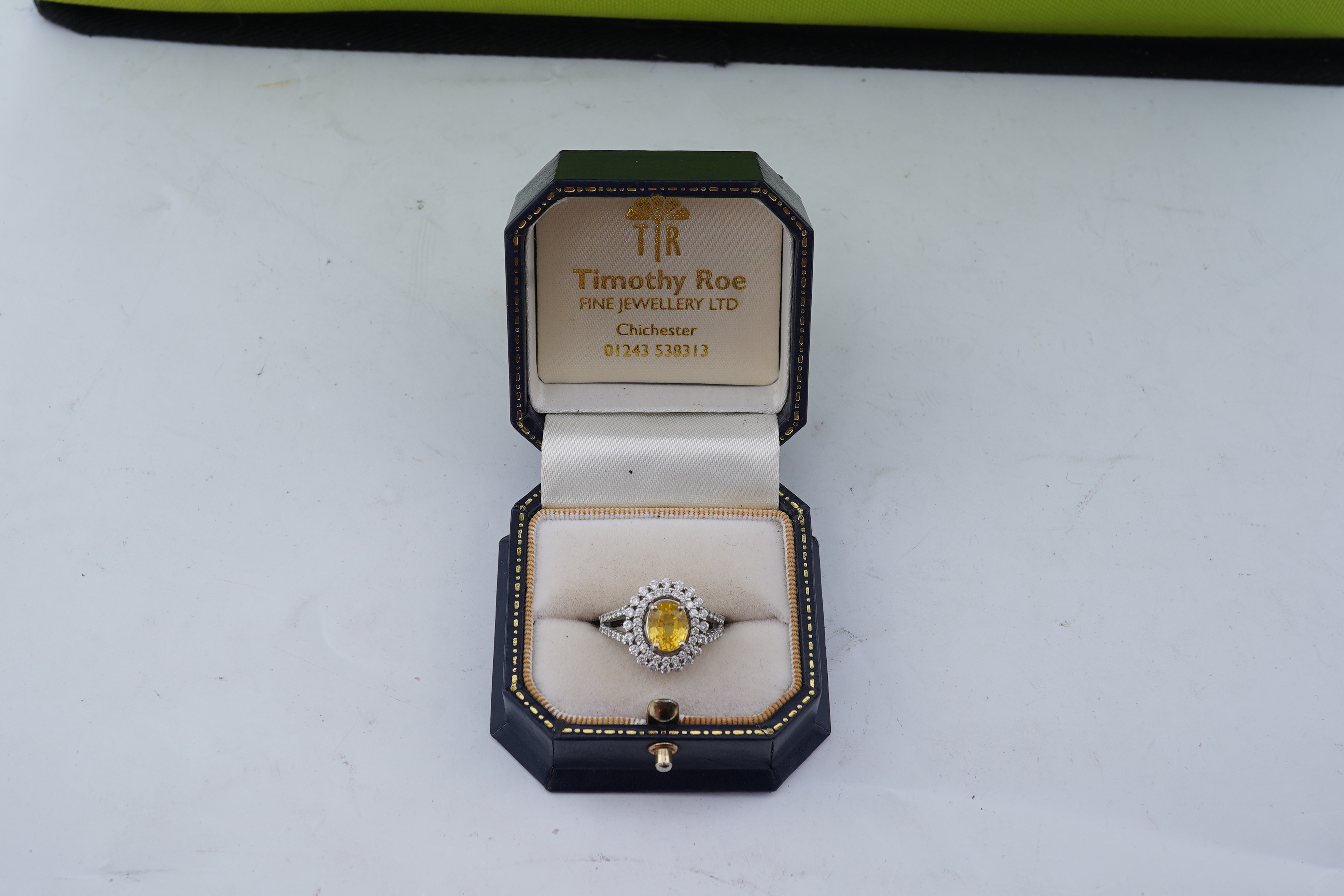 A yellow sapphire and diamond ring